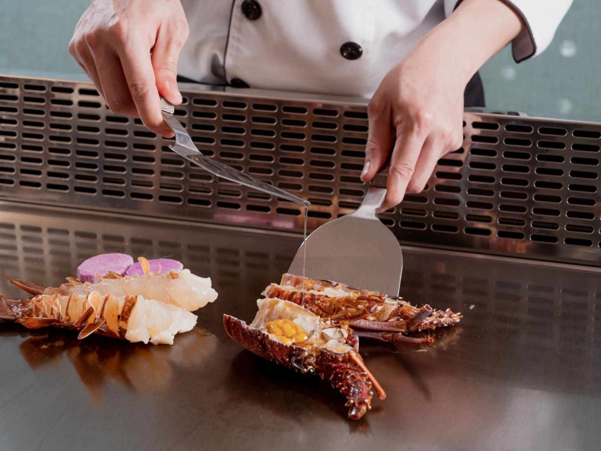 Windsor Hotel Taichung Exteriör bild A chef using a fish knife to fillet a lobster